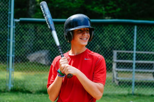 camper holding baseball bat