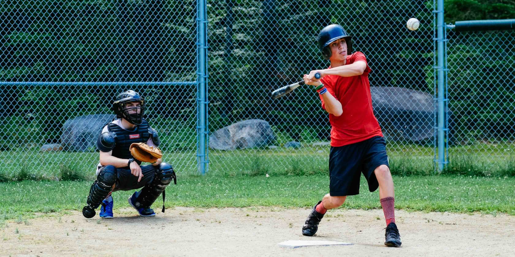 camper hitting a baseball