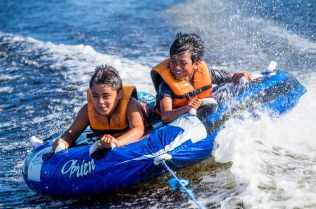 two boys watertubing