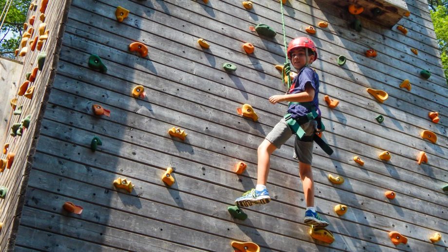 boy climbing rock wall
