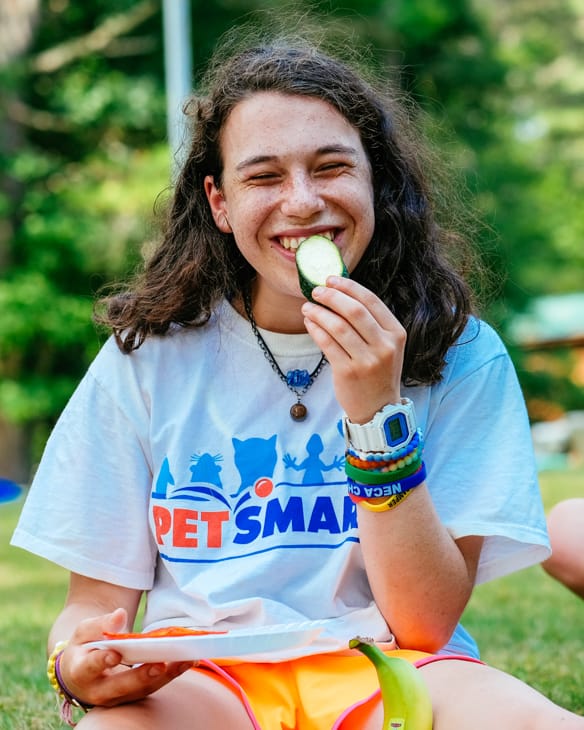 camper eating a snack outside