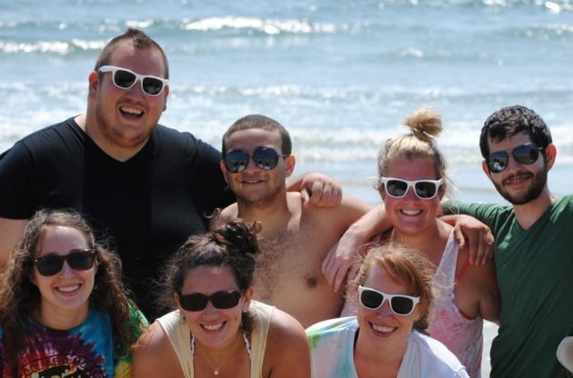 staff posing by the ocean