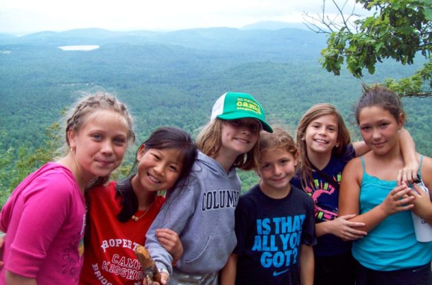 girls on a hiking trip with white mountains in the background