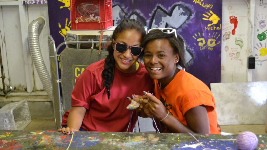 two girls at arts and crafts smiling