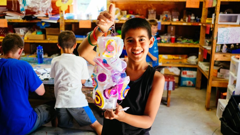boy showing off artwork
