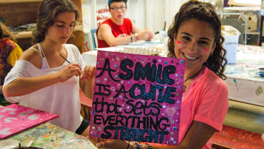 girl showing off artwork