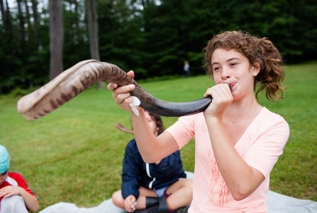 camper blowing the horn for chapel