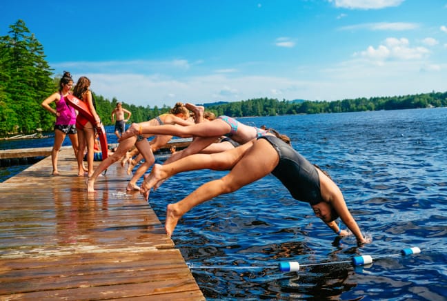 campers diving into lake