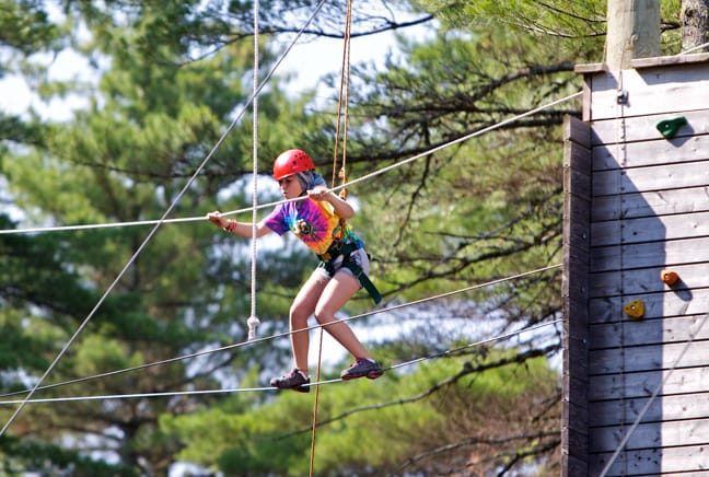 girl crossing ropes course