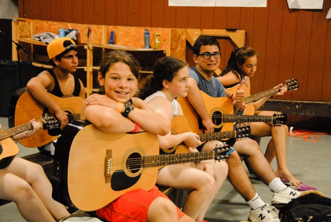 campers playing guitar in the old rec