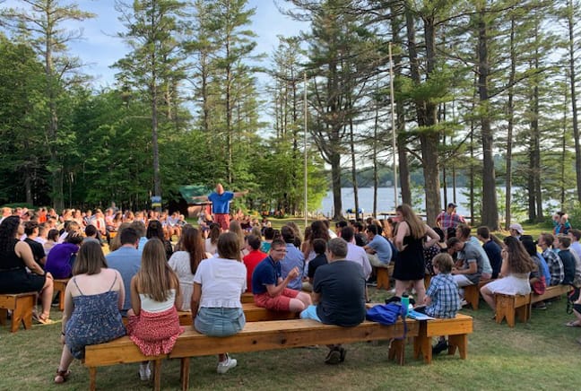 camp-wide morning meeting by the flag pole