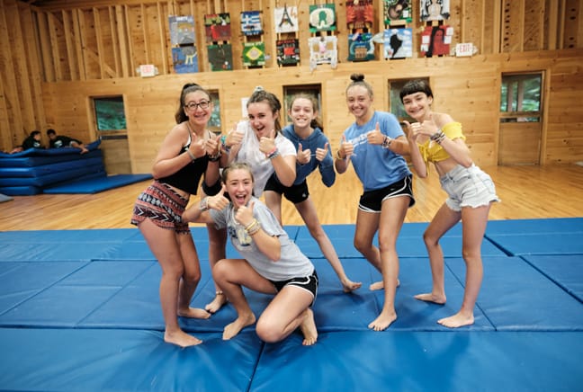 girls on a gymnastics mat