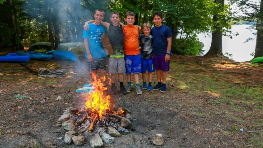 boys by a campfire they built