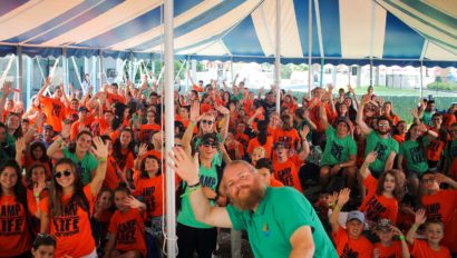 campers at color war event under a tent