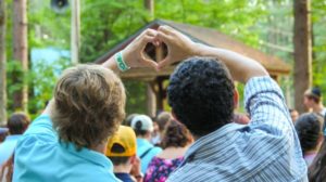 staff making a heart shape with their hands