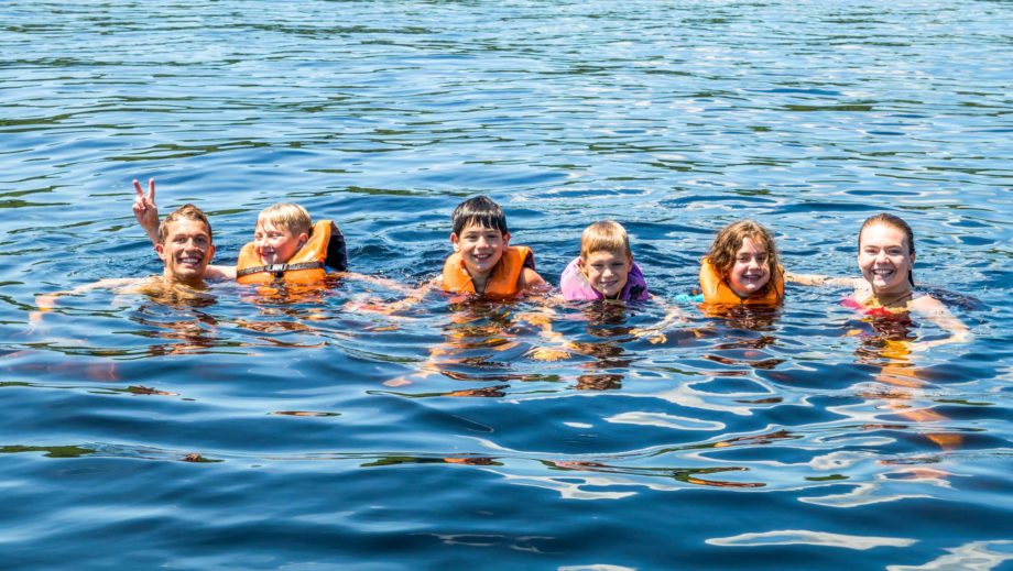 campers swimming in the lake
