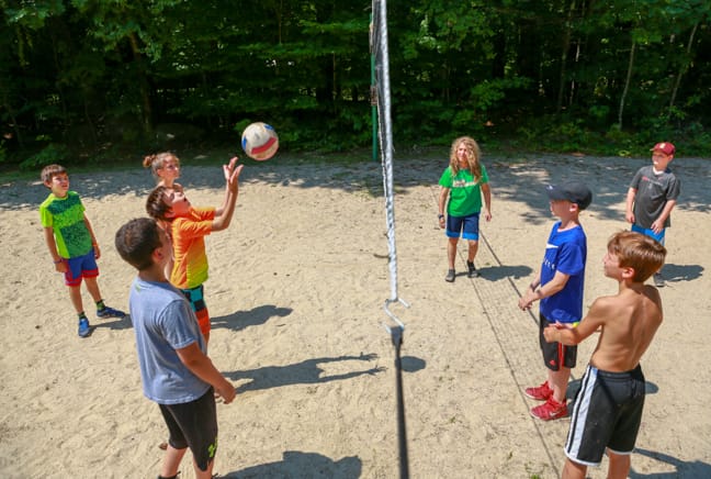 group of campers playing volleyball in the upper fields