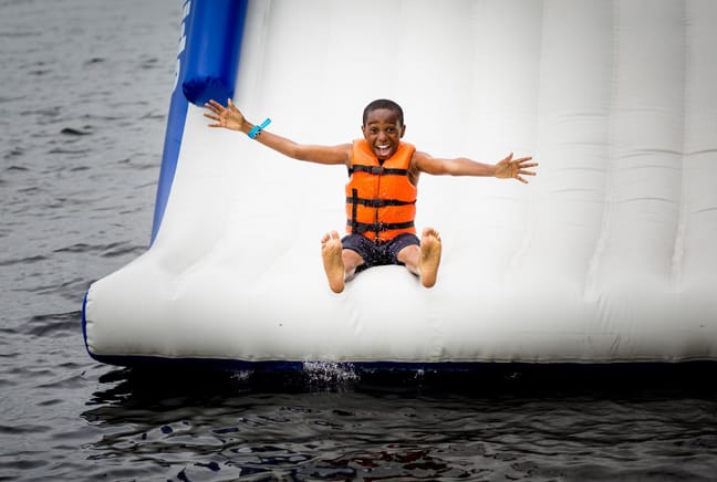 boy sliding off waterslide